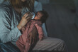 Mother holds her two moths old baby taking care of her at home - Caucasian woman with her newborn child bottle feeding milk on lap at night - Affectionate and bonding childhood and motherhood concept