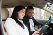 © Tetra Images - Young couple in car with digital tablet
