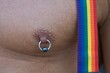 gay man chest with rainbow suspenders and  a pearcing on the nipple