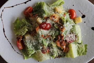 Wall Mural - caesar salad appetizer on wooden background