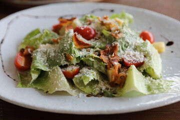 Wall Mural - caesar salad appetizer on wooden background