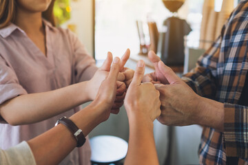 Canvas Print - A group of people making thumb up hands sign in circle