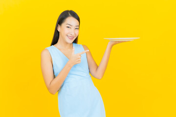 Portrait beautiful young asian woman smile with empty plate dish