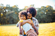 © liderina - African American mother and daughter playing in nature.