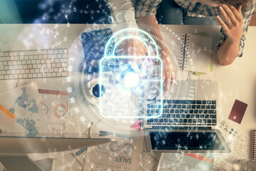 Poster - Double exposure of man and woman working together and lock hologram drawing. Security concept. Computer background. Top View.