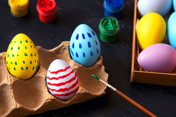 Coloring Easter eggs in different colors and patterns