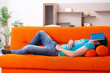 © Elnur - Young male student sitting on the orange sofa