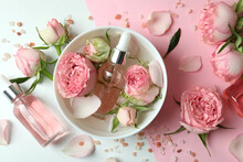 Skin Care Concept With Essential Rose Oil On Two Tone Background