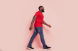 © Tetiana - Afro american guy go empty space pink color background