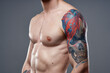© SHOTPRIME STUDIO - sporty man with pumped up press tattoo on his arms macho cropped view
