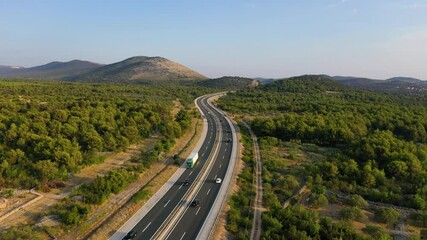 Wall Mural - aerial view on road. highway through mountain valley. view from a drone. natural landscape in summer