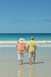 © aletia2011 - Back view. Happy elderly couple  walking  on  tropical beach