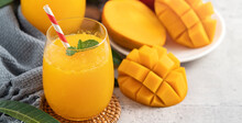 Fresh Beautiful Delicious Mango Juice Smoothie In A Glass Cup On Gray Table Background.