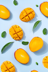 Mango design concept. Diced fresh mango fruit on blue table background.