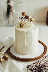 Wall Mural - Closeup shot of delicious Boho ombre cake with dry flowers on a white table