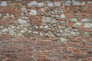 Old castle wall made of bricks and limestone