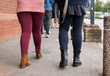 © Liz Mitchell - legs and feet of people waiting in line to enter a shop during the Covid-19 pandemic