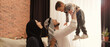 © New Africa - Happy Muslim family spending time together on sofa at home. Banner design