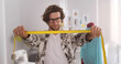 © TommyStockProject - Smiling fashion designer standing in office holding measuring tape