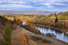 The Clutha River In The South Island Of New Zealand As It Flows Into The Small Town Of Clyde. Photographed In Autumn