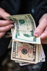 Poster - Counting or giving United States Dollars banknotes.