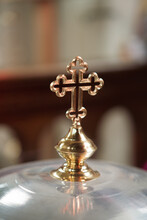 Vertical Shot Of  A Cross Of A Baptismal Font