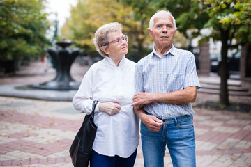 mature couple of man with a woman strolling outdoor in park