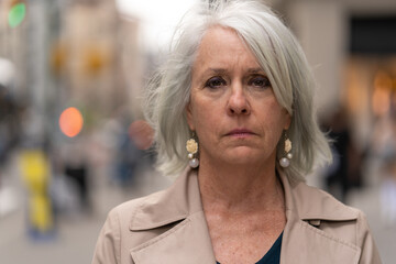 Poster - Mature caucasian woman in city serious sad face portrait