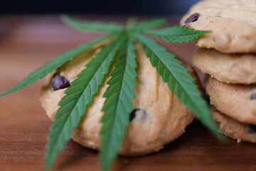 Cookies with marijuana on table. Concept of cooking with cannabis herb