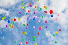 Lots Of Colorful Balloons Flying Against Blue Sky With Clouds With Copy Space. Concept Of Holiday, Festival, Children's Day, Last Call At School And Kindergarten, Birthday.