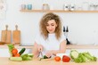 © Serhii - Woman making salad in kitchen. Healthy eating lifestyle concept with beautiful young woman cooking in her kitchen.