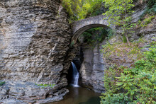 Sentry Bridge Entry Way To Watkins Glen State Park With Falls Below The Stone Arch With Cliff Walls
