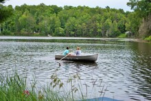 teen girls in a rowboat in the middle of a lake upper peninsula michigan