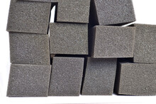 Front View Of A Pile Of Gray Spongy Foam Material In The Shape Of A Square Block Isolated On A White Background