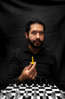 © Narayan - latin man with beard holding chess king, leadership concept