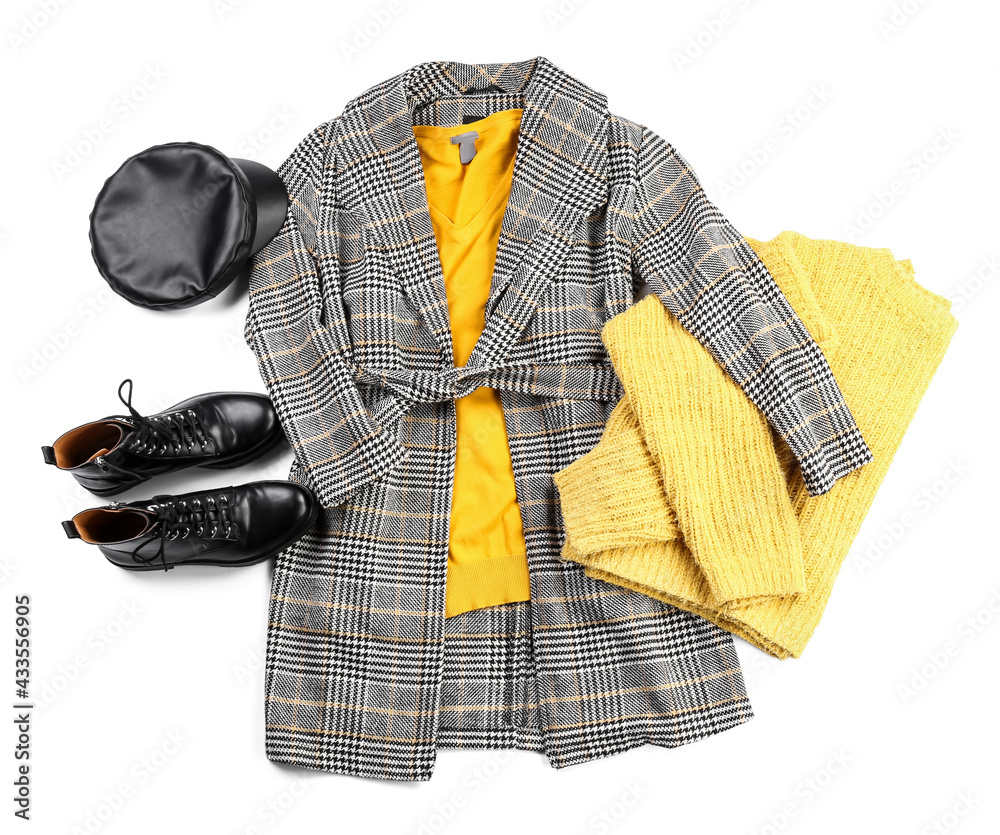 Stylish female clothes with accessories on white background