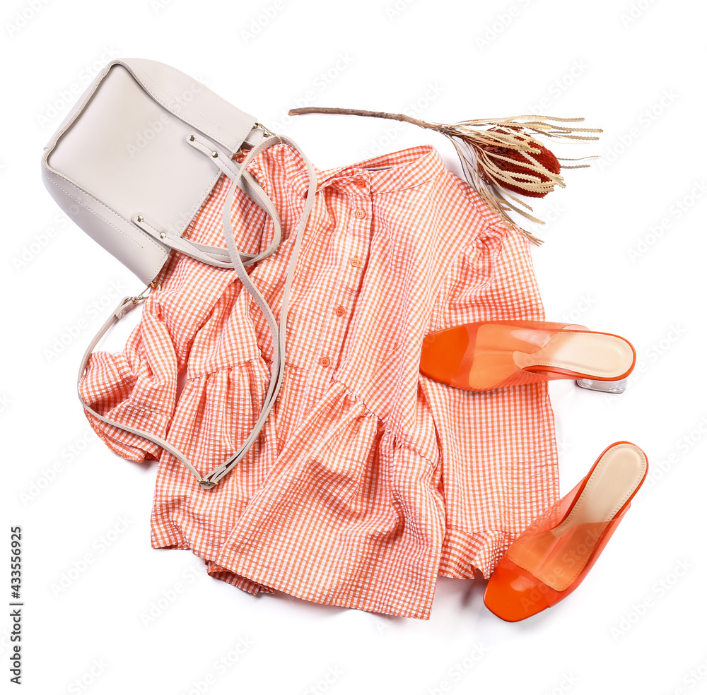 Stylish female clothes with accessories on white background