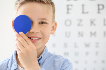 Wall Mural - Little boy undergoing eye test in clinic