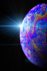 Wall Mural - Bubble color. Globe planet earth in galaxy universe space with abstract sun on black background. Color abstract fluorescent inks in water.