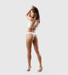 © olegphotor - White bikini mockup for design on sexy girl isolated on background, back view