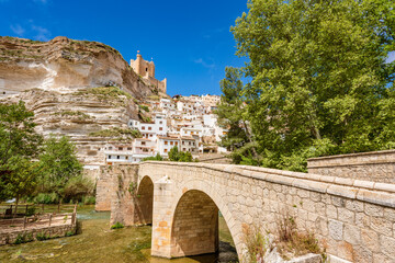 Alcalá del Júcar, La Manchuela, Spain. Picturesque and touristic white town in a River Jucar meander with a stone bridge.