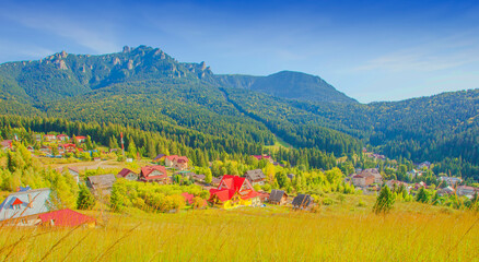 Wall Mural - Durau mountain resort in Romanian Carpathians. Ceahlau peak in background. autumn landscape