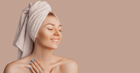 Wall Mural - beautiful sensual young girl with clean skin on a beige background with a mockup. topless woman in a