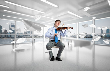 young businessman playing violin