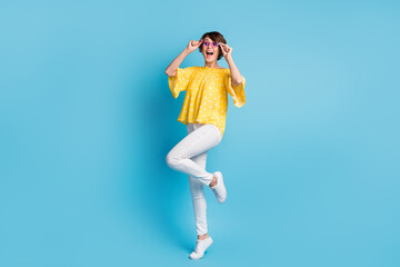 Poster - Full body photo of amazed brunette young woman look empty space hold glasses isolated on pastel blue color background