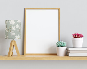 Poster - Picture or poster mockup with wooden frame, wooden lamp, books and plants on the shelf. Clipping path for the poster included. 3D render. 3D illustration.