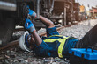 © arrowsmith2 - African machine engineer technician wearing a helmet, groves and safety vest is using a wrench to repair the train