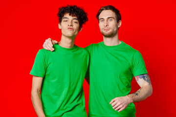 Two cheerful friends hug green t-shirts emotions 