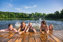 Happy children enjoying summer holidays at a lake