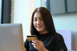 © Jirapong - Online payment with Young Women hands holding  credit card and using computer  for online shopping